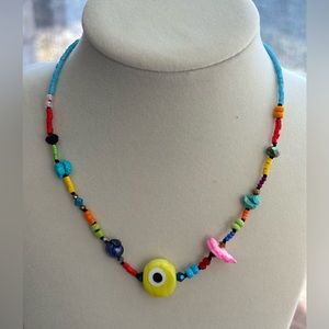 A handmade piece. Yellow evil eye necklace for women or teens.